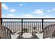 Ocean view balcony with two chairs and table at 1501 S Ocean Blvd. # 530, Myrtle Beach, SC 29577