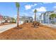 Front yard view of the home with palm trees, a three-car garage, and landscaped lawn at 1531 Biltmore Dr., Myrtle Beach, SC 29579