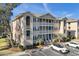 Three-story condo building with balconies and parking in a quiet setting at 1900 Duffy St. # H-9, North Myrtle Beach, SC 29582