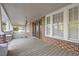 Inviting front porch with brick columns and wood flooring at 205 S Nichols St., Nichols, SC 29581