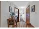 Bright entryway with tile floor, console table, and view to living area at 4800 S Ocean Blvd. # 412, North Myrtle Beach, SC 29582
