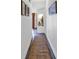 Hallway with jute rug, built-in niche, and ocean-themed art at 4800 S Ocean Blvd. # 412, North Myrtle Beach, SC 29582