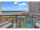 Stunning ocean view from balcony with seating and small table at 4800 S Ocean Blvd. # 412, North Myrtle Beach, SC 29582