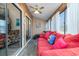 Relaxing sunroom with red couch and sliding glass doors at 500 Fairway Village Dr. # 6B, Myrtle Beach, SC 29588