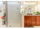 Bathroom with shower, granite vanity and wood cabinets at 646 Uniola Dr., Myrtle Beach, SC 29579