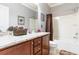 Bathroom with granite countertop, brown wooden vanity, and shower/tub combo at 646 Uniola Dr., Myrtle Beach, SC 29579