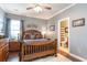 Bedroom with wooden bed frame, ensuite bathroom, and ample natural light at 646 Uniola Dr., Myrtle Beach, SC 29579