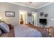 Main bedroom with large bed, TV, and access to bathroom and closet at 646 Uniola Dr., Myrtle Beach, SC 29579