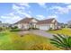 House exterior showcasing a spacious driveway and manicured lawn at 646 Uniola Dr., Myrtle Beach, SC 29579