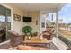 Screened porch with wicker furniture and view of backyard and lake at 646 Uniola Dr., Myrtle Beach, SC 29579