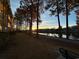 Stunning waterfront sunset view with tall trees and calm water at 695 Riverwalk Dr. # 5-302, Myrtle Beach, SC 29579