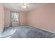 Bedroom with blue carpet, pink walls, a window with curtains, and a ceiling fan at 106 Moss Circle, Conway, SC 29526