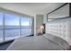Bedroom featuring a comfortable bed, large windows with ocean views at 107 S Ocean Blvd. # 701, Myrtle Beach, SC 29577