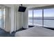 Oceanfront bedroom with large windows, wall-mounted TV, and comfortable bed at 107 S Ocean Blvd. # 701, Myrtle Beach, SC 29577