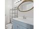 Bathroom with blue vanity, white sink, and decorative mirror at 1100 Possum Trot Rd. # E235, North Myrtle Beach, SC 29582