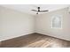 Empty bedroom with wood-look flooring, ceiling fan, and window at 1100 Possum Trot Rd. # E235, North Myrtle Beach, SC 29582