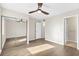 Bedroom with ceiling fan, mirrored closet doors, and wood-look flooring at 1100 Possum Trot Rd. # E235, North Myrtle Beach, SC 29582