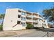 Exterior view of the building with balconies, and shrubs at 1100 Possum Trot Rd. # E235, North Myrtle Beach, SC 29582