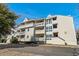 View of the condo building showcasing balconies and nearby trees at 1100 Possum Trot Rd. # E235, North Myrtle Beach, SC 29582