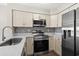 Updated kitchen with stainless steel appliances and white cabinetry at 1100 Possum Trot Rd. # E235, North Myrtle Beach, SC 29582