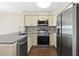 Updated kitchen featuring stainless steel appliances, white shaker cabinets, and stone countertops at 1100 Possum Trot Rd. # E235, North Myrtle Beach, SC 29582