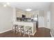 Modern kitchen with stainless steel appliances, light wood cabinets, and breakfast bar seating at 1100 Possum Trot Rd. # E235, North Myrtle Beach, SC 29582