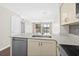 Open kitchen with stainless steel appliances, white cabinetry, and breakfast bar at 1100 Possum Trot Rd. # E235, North Myrtle Beach, SC 29582