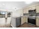 Kitchen with stainless steel appliances, light cabinets, and an open view to the living area at 1100 Possum Trot Rd. # E235, North Myrtle Beach, SC 29582