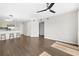 Open living area with wood-look flooring, ceiling fan, and view of the kitchen at 1100 Possum Trot Rd. # E235, North Myrtle Beach, SC 29582