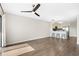 Open living area with wood floors, ceiling fan, breakfast bar, and view of the kitchen at 1100 Possum Trot Rd. # E235, North Myrtle Beach, SC 29582