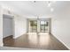 Living room with wood-look floors, sliding glass doors leading to a balcony, and a ceiling fan at 1100 Possum Trot Rd. # E235, North Myrtle Beach, SC 29582