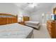 View of bedroom with two beds, dresser, ceiling fan, and ensuite bathroom access at 116 Cypress Point Ct. # 102, Myrtle Beach, SC 29579