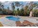 Relaxing kidney-shaped pool with lounge chairs and outdoor fireplace at 154 Southgate Ct., Pawleys Island, SC 29585