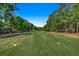 Expansive green golf course with lush trees and clear sunny sky at 1824 Laurel Trail # 1-B, Murrells Inlet, SC 29576