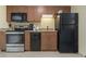Compact kitchen featuring black appliances and wood cabinetry at 2100 North Ocean Blvd. # 923, North Myrtle Beach, SC 29582