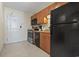 Kitchen with black appliances, wood cabinets, and tile flooring at 2100 North Ocean Blvd. # 923, North Myrtle Beach, SC 29582