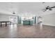 Open-concept kitchen and dining area with teal cabinets, island, and tile floors at 2231 Flora St., Georgetown, SC 29440