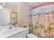 Bathroom featuring a beach-themed shower curtain and white vanity at 239 Coachman Dr., Pawleys Island, SC 29585