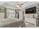 Spacious bedroom with a ceiling fan, large window, and ample storage at 239 Coachman Dr., Pawleys Island, SC 29585