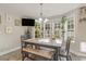 Bright dining area with large windows, a wooden table, and seating for six at 239 Coachman Dr., Pawleys Island, SC 29585
