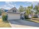 Charming two-story home with a welcoming front porch and landscaped yard at 239 Coachman Dr., Pawleys Island, SC 29585