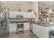 Modern kitchen featuring stainless steel appliances, granite countertops, and white cabinetry at 239 Coachman Dr., Pawleys Island, SC 29585