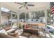 Relaxing sunroom with comfortable seating, hammock, and backyard views at 239 Coachman Dr., Pawleys Island, SC 29585