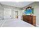 King-size bed, dresser, and TV in a condo bedroom at 2600 North Ocean Blvd. # 211, Myrtle Beach, SC 29577