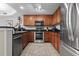 Modern kitchen with stainless steel appliances and wood cabinets at 2600 North Ocean Blvd. # 211, Myrtle Beach, SC 29577