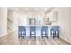 Kitchen with island seating, wood-look flooring, and a view of the staircase at 268 Empyrean Circle, Myrtle Beach, SC 29588