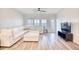Spacious living room featuring a comfortable sectional, wood-look floors, and a door leading to the outdoors at 268 Empyrean Circle, Myrtle Beach, SC 29588