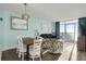 Dining area with a wooden table, white chairs, a couch, and ocean views at 2801 S Ocean Blvd. # 1237, North Myrtle Beach, SC 29582