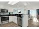 Bright, open kitchen with white cabinets, stainless steel appliances, and a breakfast bar at 2801 S Ocean Blvd. # 1237, North Myrtle Beach, SC 29582