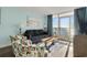 Living room with a sofa, armchairs, sliding glass door leading to an ocean view balcony at 2801 S Ocean Blvd. # 1237, North Myrtle Beach, SC 29582